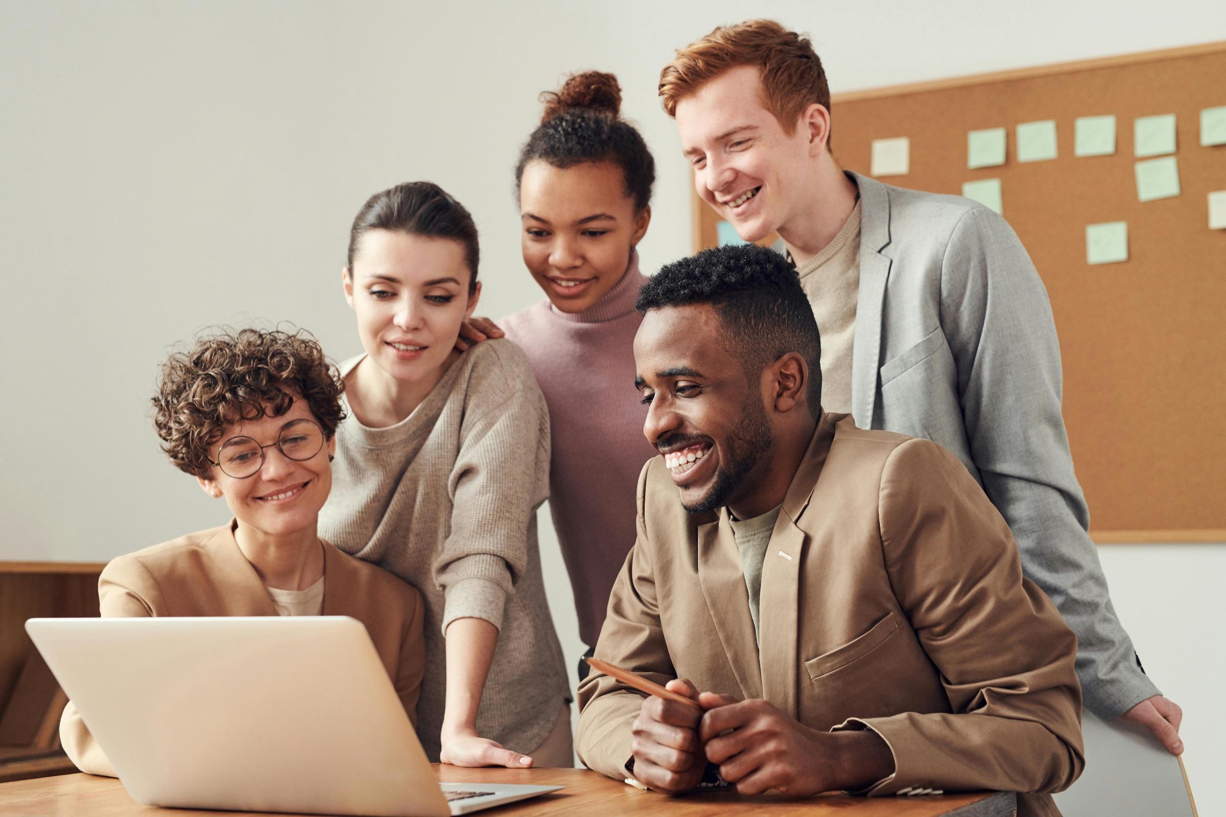 Teachers reviewing a lesson together on a laptop
